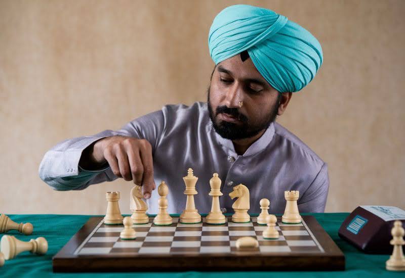 image of a person checking out his chess pieces