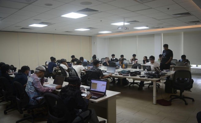 Chess players competing at laptops during the Battle of Brains tournament in Chennai