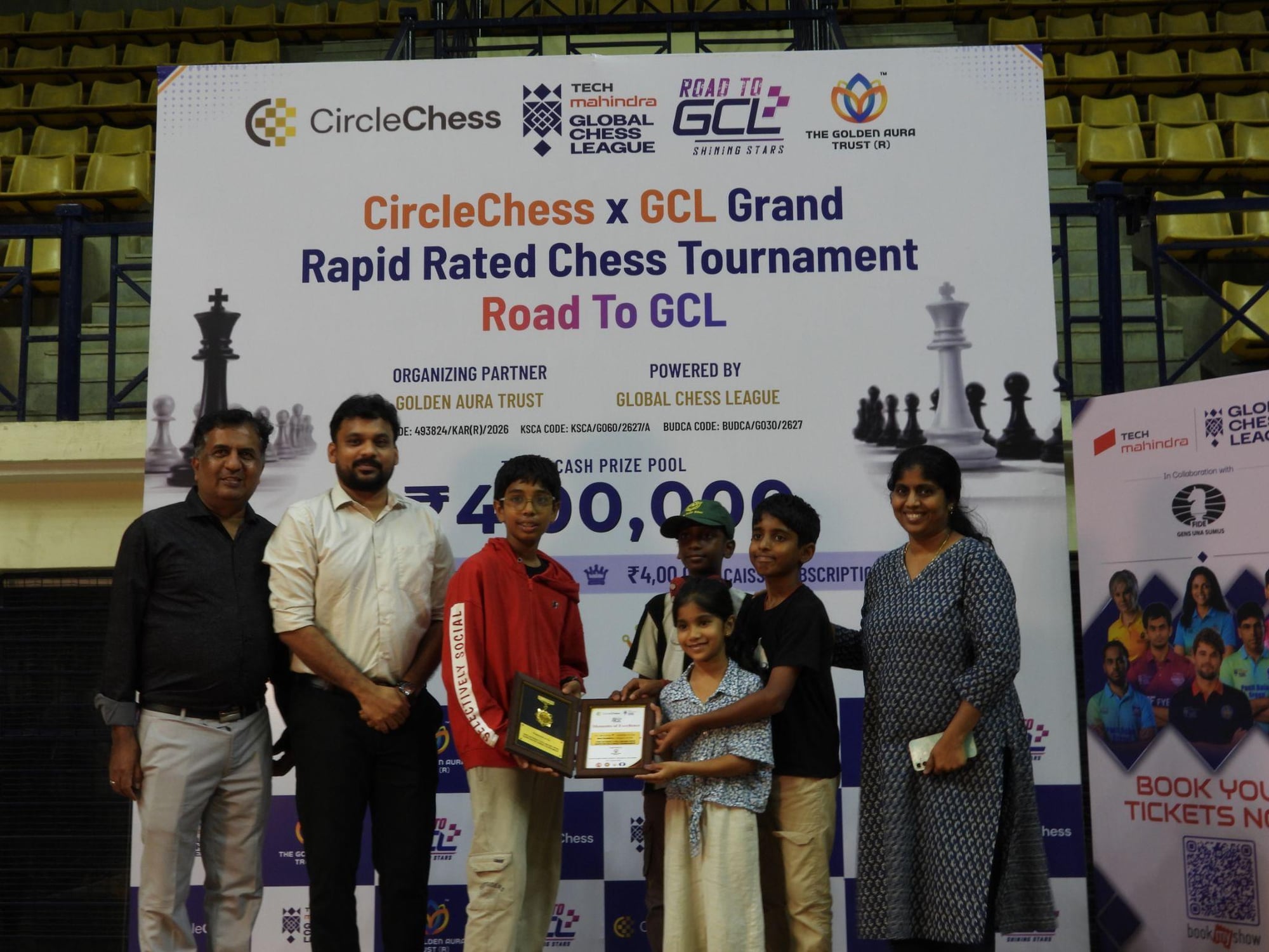 IM Apoorv Kamble receiving his winner's trophy and prize on stage at the CircleChess x GCL Grand Open