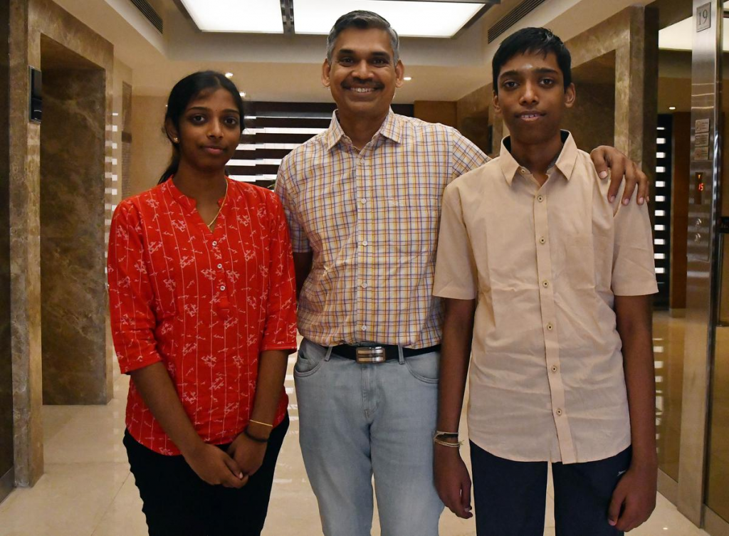 An image of the coach of praggnanandha with him and his sister
